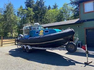 Zodiac Hurricane EH 733 Zodiac Hurricane EH 733 boat on trailer, parked outdoors near a house, 2017 model.