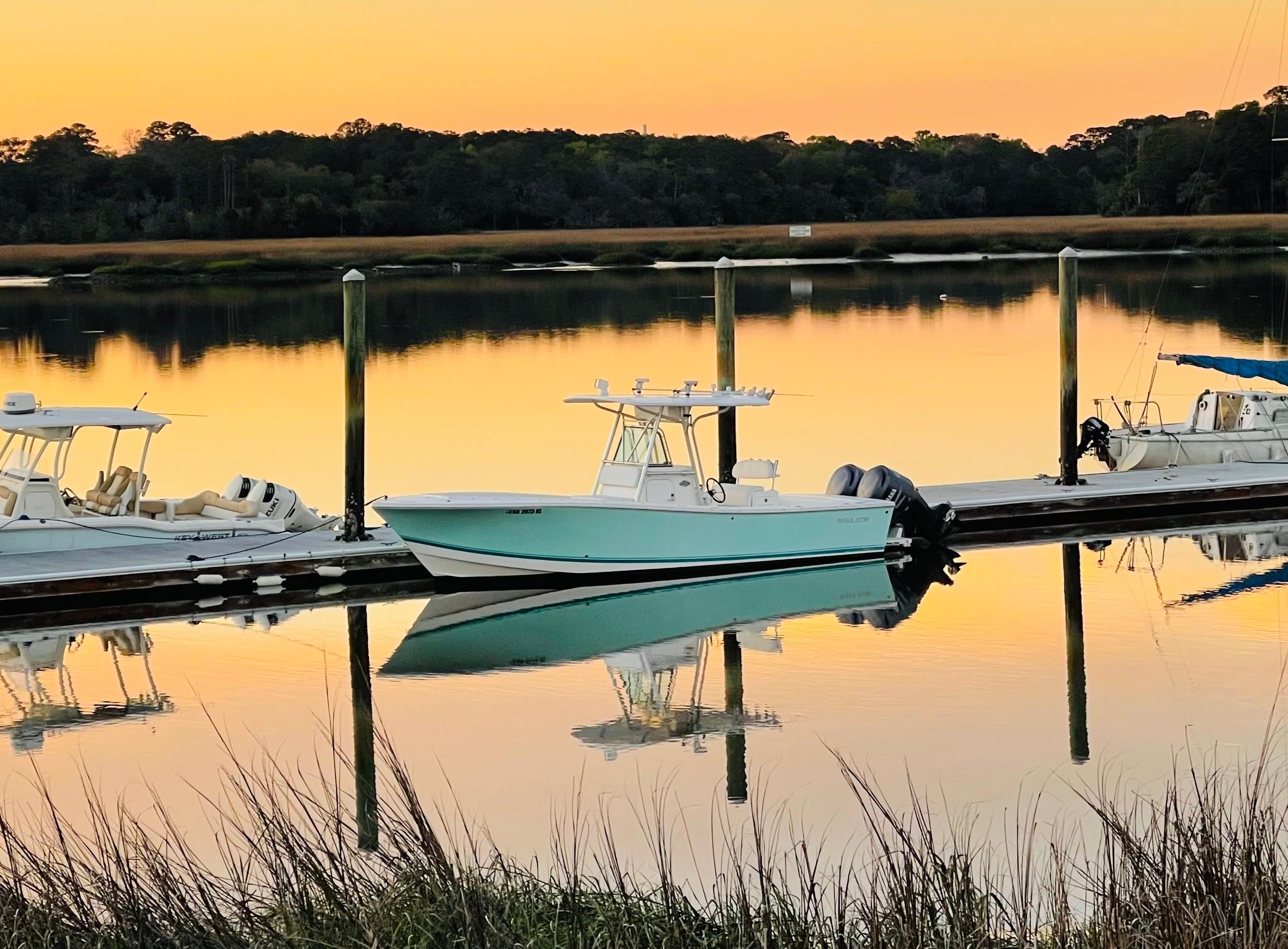 Regulator 26 Forward Seating 2006 Regulator 26 Forward Seating boat docked at sunset, reflecting on calm water.
