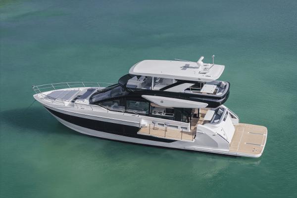 Cruisers Yachts 57 Fly 2025 Cruisers Yachts 57 Fly luxury yacht on clear turquoise water.