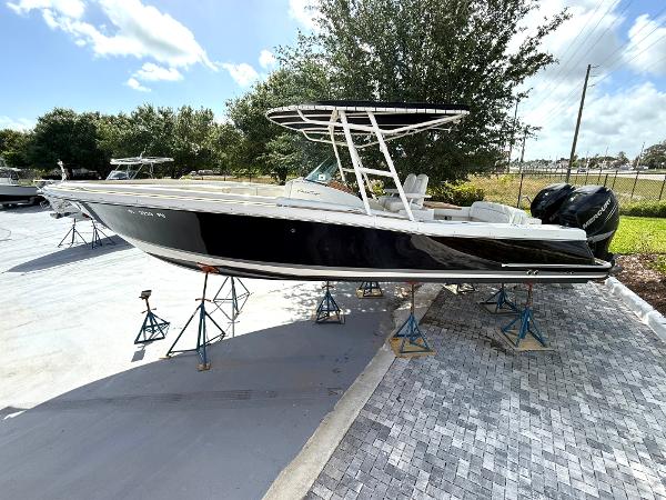 Chris-Craft Catalina 29 2014 Chris-Craft Catalina 29 boat on stands, black hull, outdoor setting.