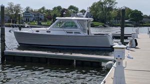 Back Cove 30 2011 Back Cove 30 boat docked at a marina, surrounded by calm water and greenery.