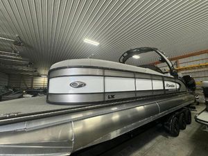 Manitou LX 2025 Manitou LX pontoon boat in a storage facility.