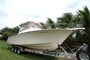 Grady-White Express 330 2007 Grady-White Express 330 boat on trailer, surrounded by palm trees.