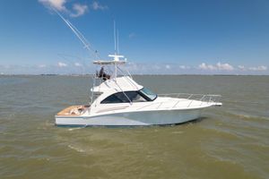 Hatteras GT45X Flybridge 2018 Hatteras GT45X Flybridge yacht cruising on open water under clear blue skies.