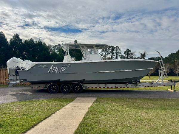Invincible 35 Catamaran 2022 Invincible 35 Catamaran on trailer, parked outdoors with cloudy sky backdrop.