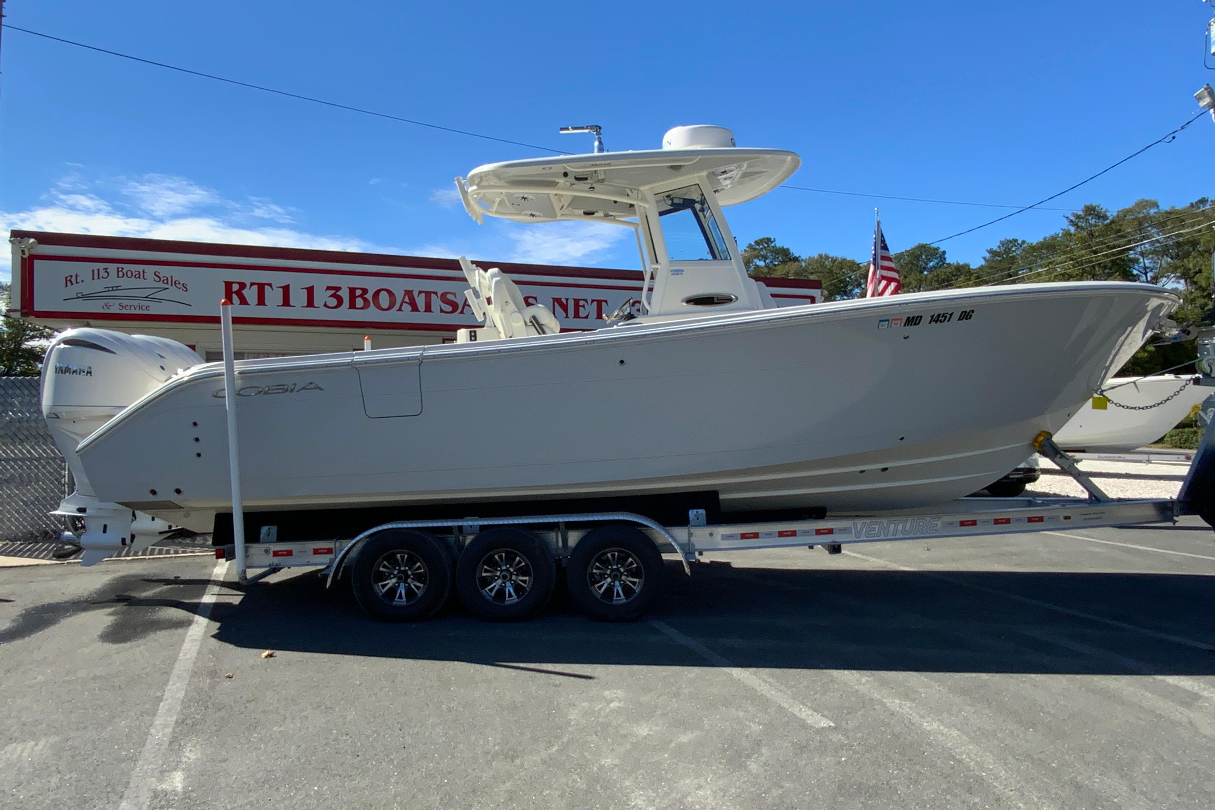 Cobia 285 Open Center Console 2025 Cobia 285 Open Center Console boat on trailer at dealership.