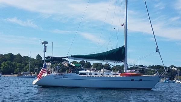 Freedom 45AC Sailboat Freedom 45AC, 1992 model, anchored on a sunny day with a scenic shoreline backdrop.