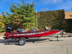 Tracker Pro Team 190 2025 Tracker Pro Team 190 boat, red, parked outdoors on a trailer.
