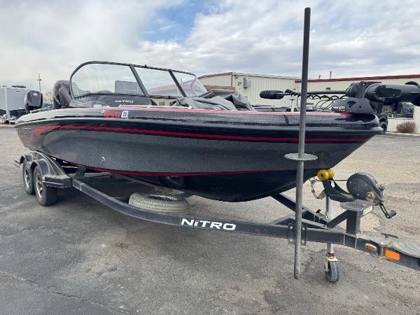Nitro ZV21 2019 Nitro ZV21 boat on trailer, black with red accents, parked outdoors.