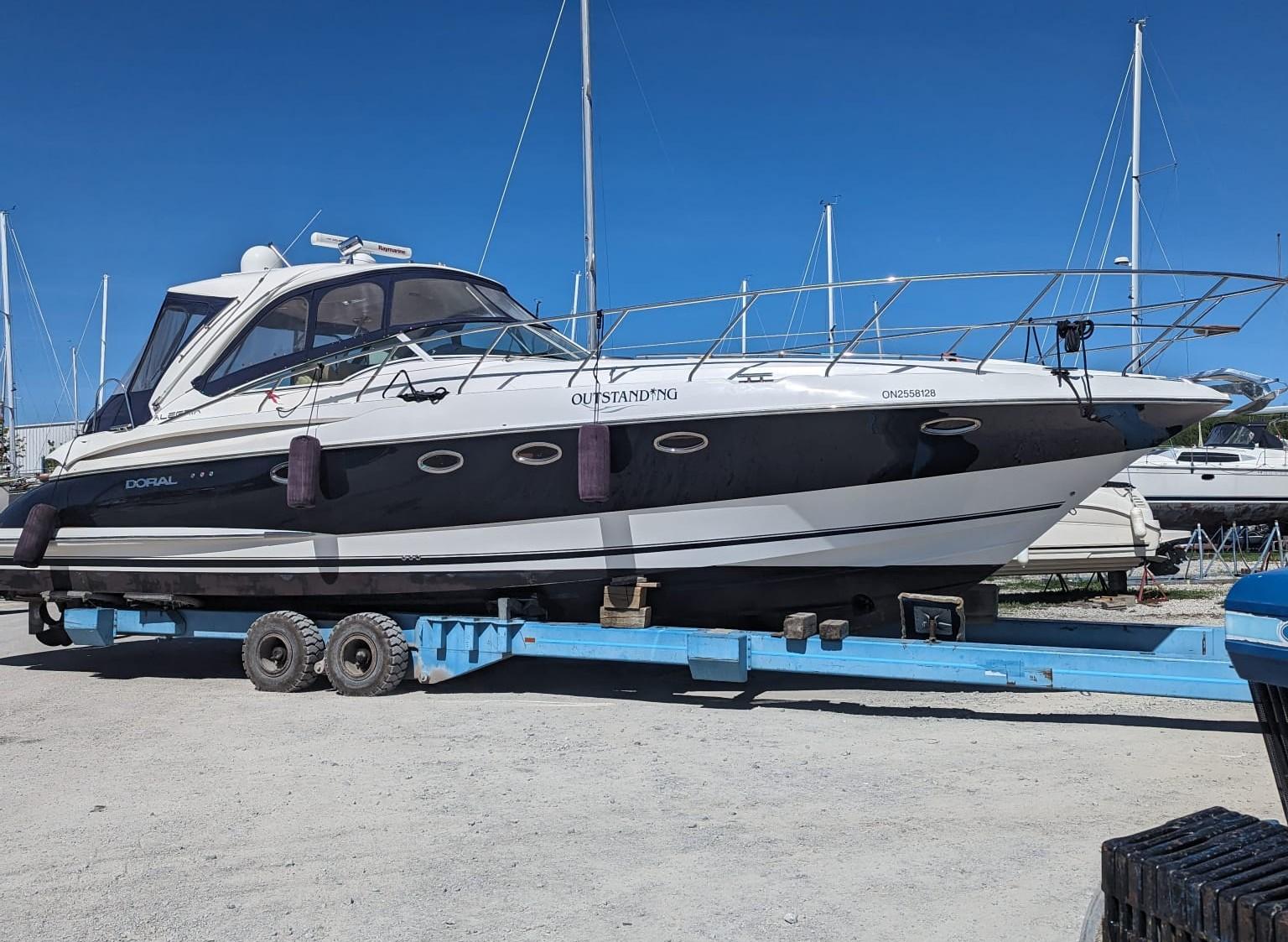 Doral Alegria 2007 Doral Alegria yacht on trailer, marina background, clear blue sky.