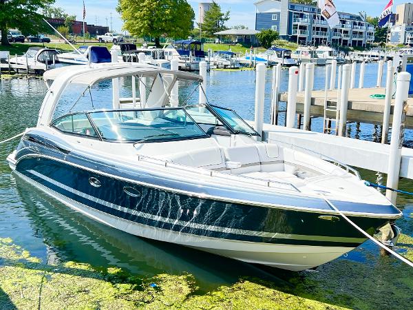 Formula 330 CRB 2018 Formula 330 CRB boat docked in a marina, surrounded by water and greenery.