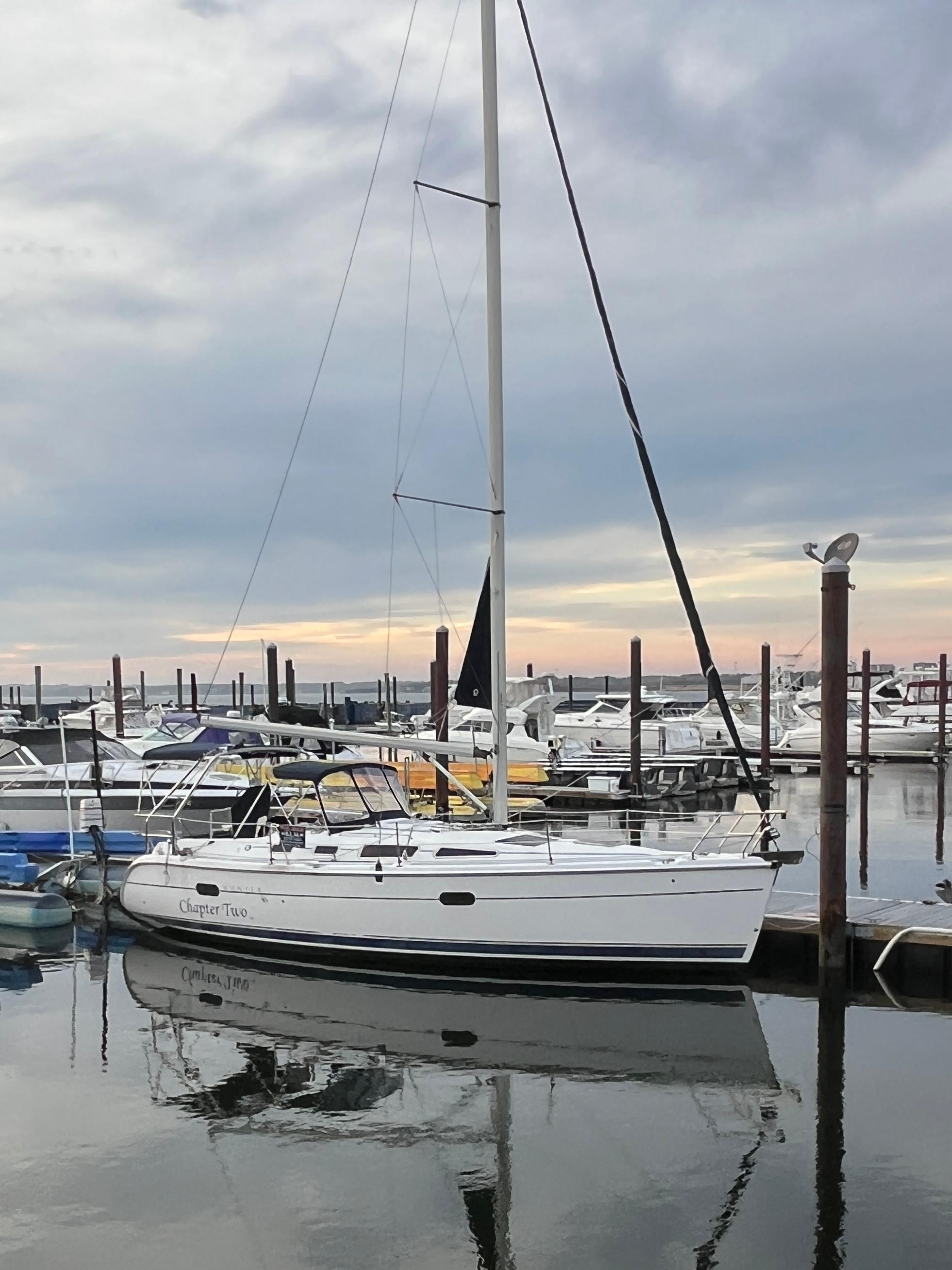 Hunter 36 2006 Hunter 36 sailboat docked at marina under cloudy sky.