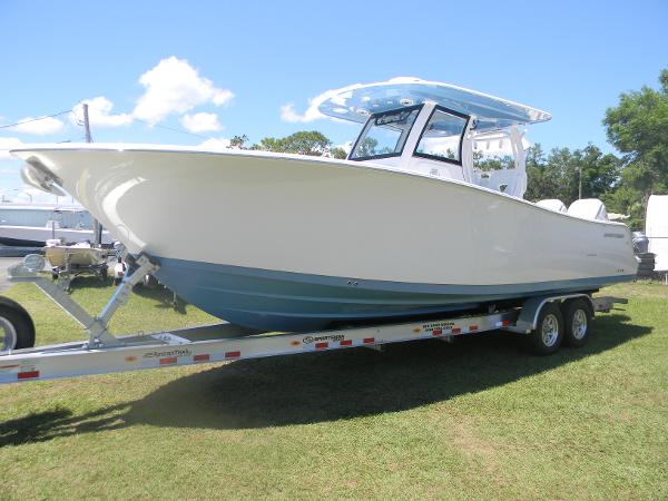 Sportsman Open 302 Center Console 2025 Sportsman Open 302 Center Console boat on trailer, parked on grass.