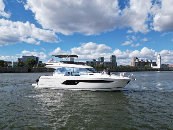 Prestige 520 2020 Prestige 520 yacht cruising on a river with cityscape background.