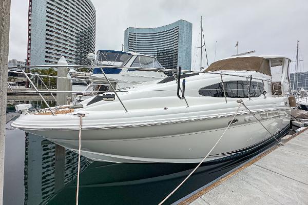 Sea Ray 390 Motor Yacht 2004 Sea Ray 390 Motor Yacht docked at marina, modern buildings in background.