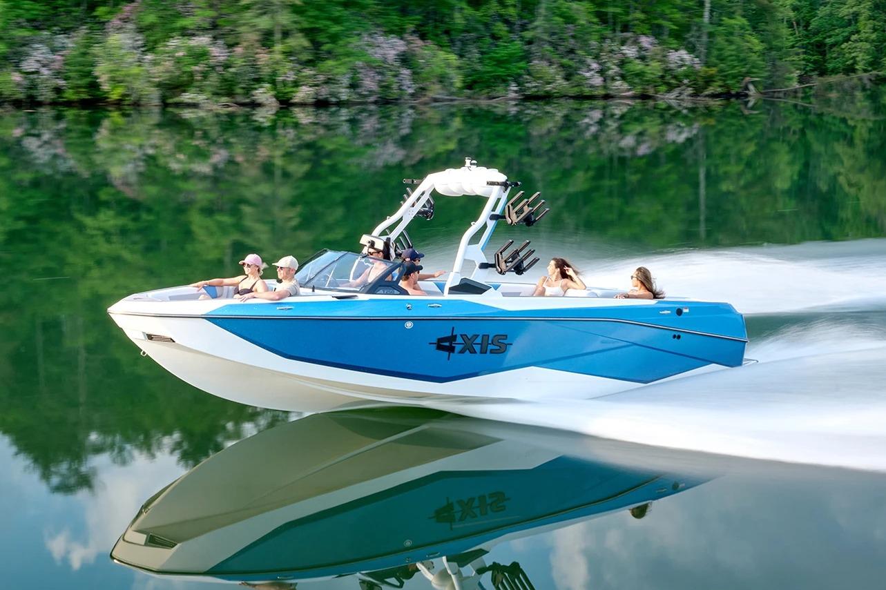 Axis T250 Manufacturer Provided Image: 2026 Axis T250 boat cruising on a serene lake with passengers enjoying the ride.