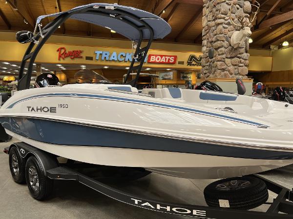 Tahoe 1950 2023 Tahoe 1950 boat on display in showroom with trailer.