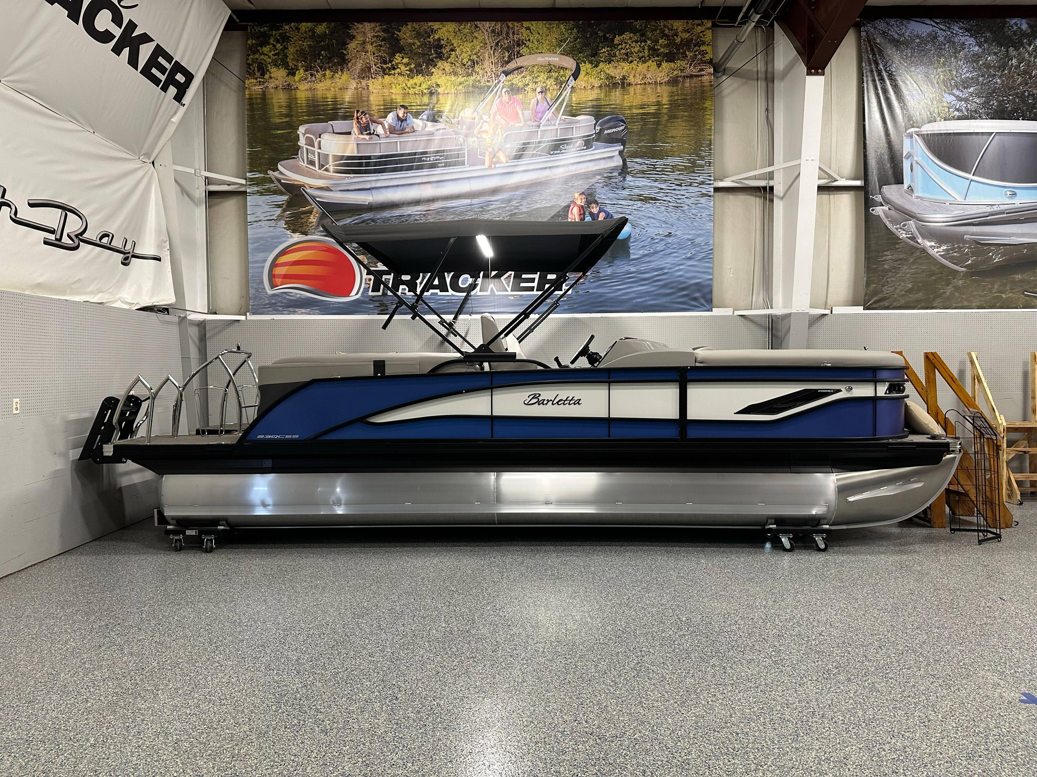 Barletta CORSA 23QC 2025 Barletta CORSA 23QC pontoon boat displayed indoors with promotional banners.