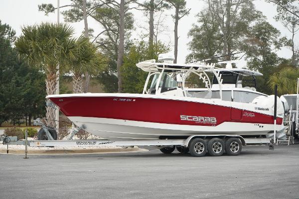 Wellcraft 302 Fisherman 2018 Wellcraft 302 Fisherman boat on trailer, red and white design, parked outdoors.