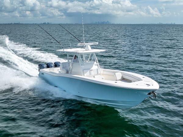 Invincible 36 2018 Invincible 36 boat cruising on open water with city skyline in background.