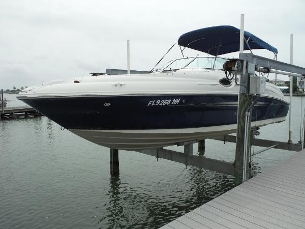 Sea Ray 240 Sundeck 2007 Sea Ray 240 Sundeck boat docked on a lift at a marina.
