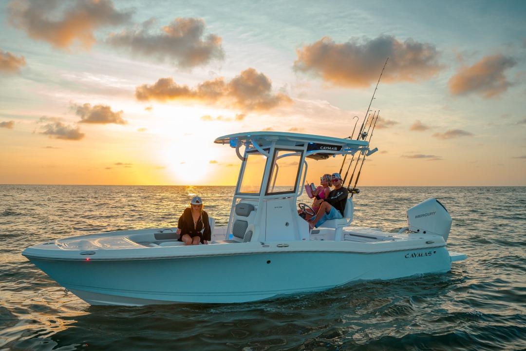 Caymas 24 HB 2026 Caymas 24 HB boat on ocean at sunset with passengers enjoying the view.