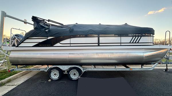 Bennington 23 L Fastback 2023 Bennington 23 L Fastback pontoon boat on a trailer, covered and parked.