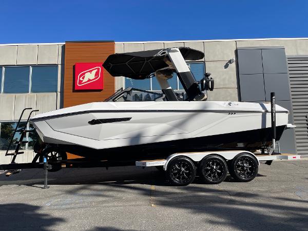 Nautique Super Air Nautique G23 2025 Nautique Super Air Nautique G23 boat on trailer, parked outside a modern building.