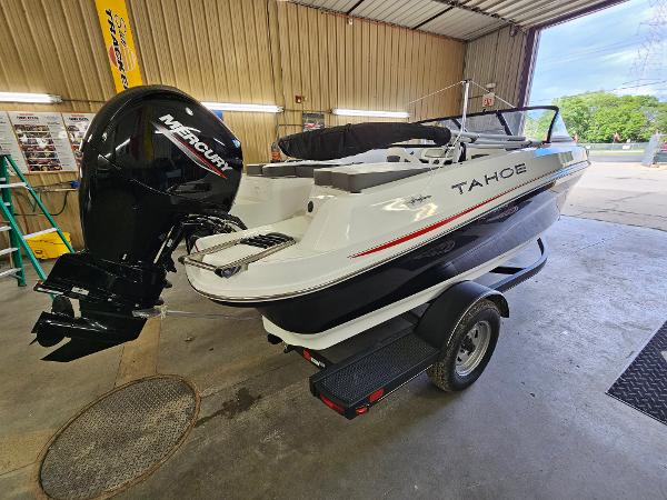 Tahoe 185 S 2024 Tahoe 185 S boat with Mercury outboard motor in a garage.