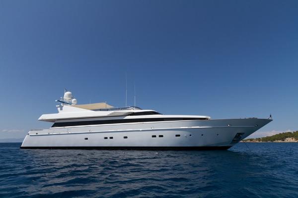 Cantieri di Pisa Akhir 125 Luxury yacht Cantieri di Pisa Akhir 125, 2004 model, cruising on open sea under clear blue sky.