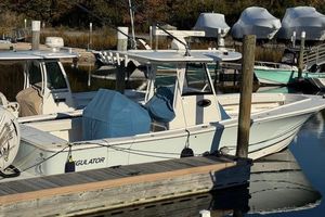 Regulator 31 2023 Regulator 31 boat docked at a marina, surrounded by other vessels.
