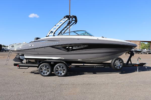Crownline Eclipse E255 SURF 2024 Crownline E255 Surf boat on a trailer, side view, outdoors.