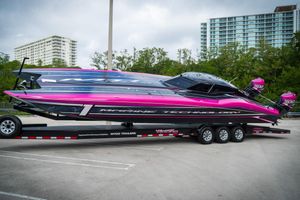 MTI 390XR 2023 MTI 390XR powerboat with vibrant pink and black design on a trailer.
