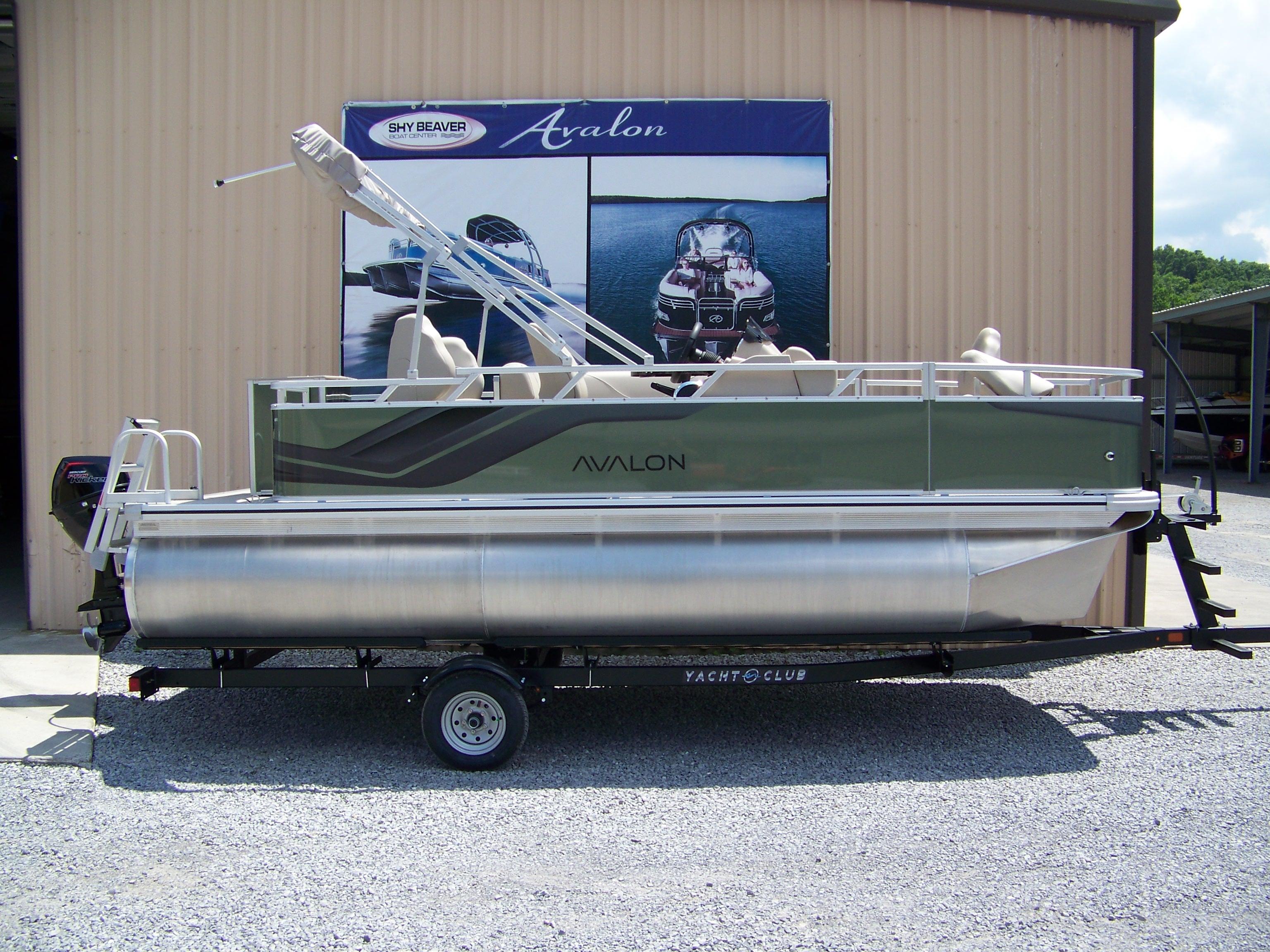 Avalon VTX Quad Fish 2025 Avalon VTX Quad Fish pontoon boat on trailer outside dealership.