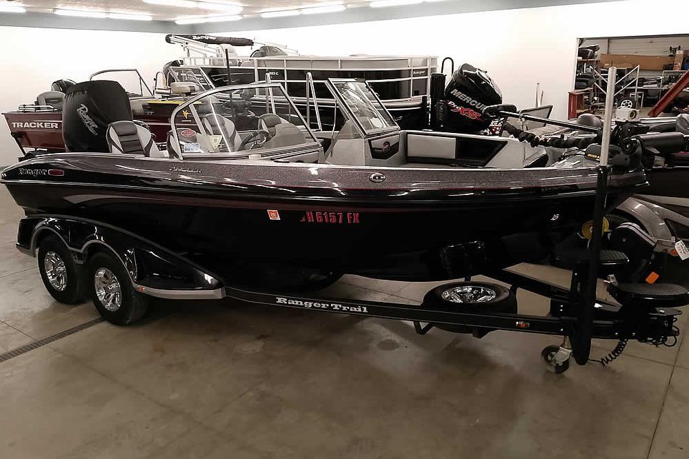 Ranger 1880MS Angler 2020 Ranger 1880MS Angler boat in showroom, featuring sleek design and dual-axle trailer.