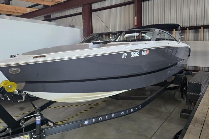 Four Winns H1 2023 Four Winns H1 boat on trailer in indoor storage facility.