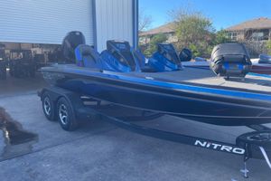 Nitro Z19 XL Pro 2026 Nitro Z19 XL Pro boat in blue, parked outside a garage.