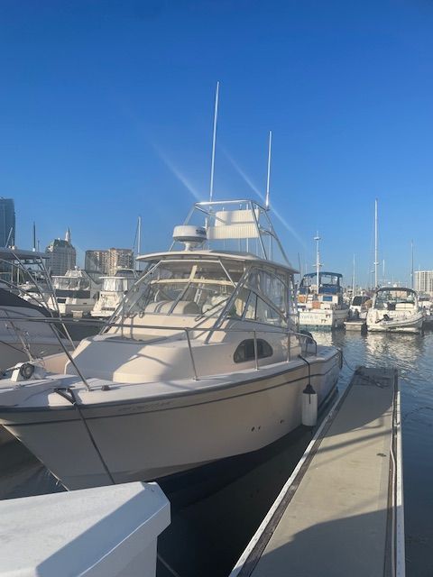 Grady-White Marlin 300 2004 Grady-White Marlin 300 boat docked at a marina under clear blue skies.