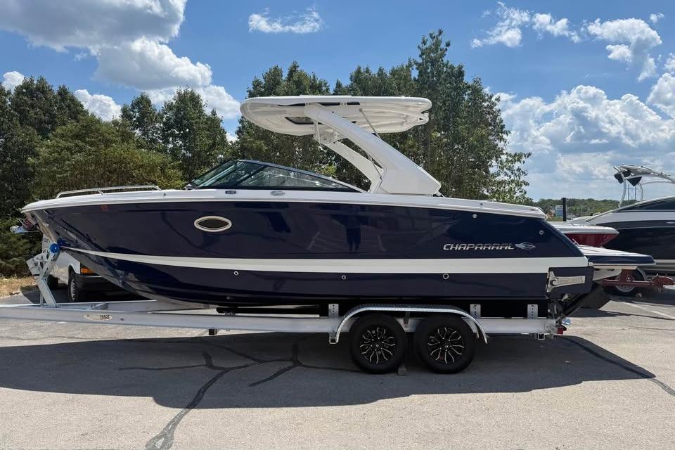 Chaparral 28 Surf 2022 Chaparral 28 Surf boat on trailer, parked outdoors under a cloudy sky.
