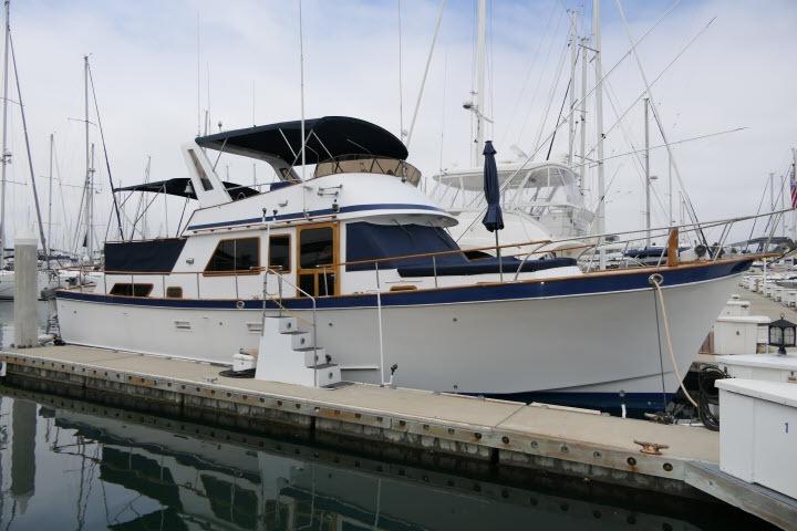 CHB 45 1983 CHB 45 yacht docked at marina, featuring classic design and spacious deck.