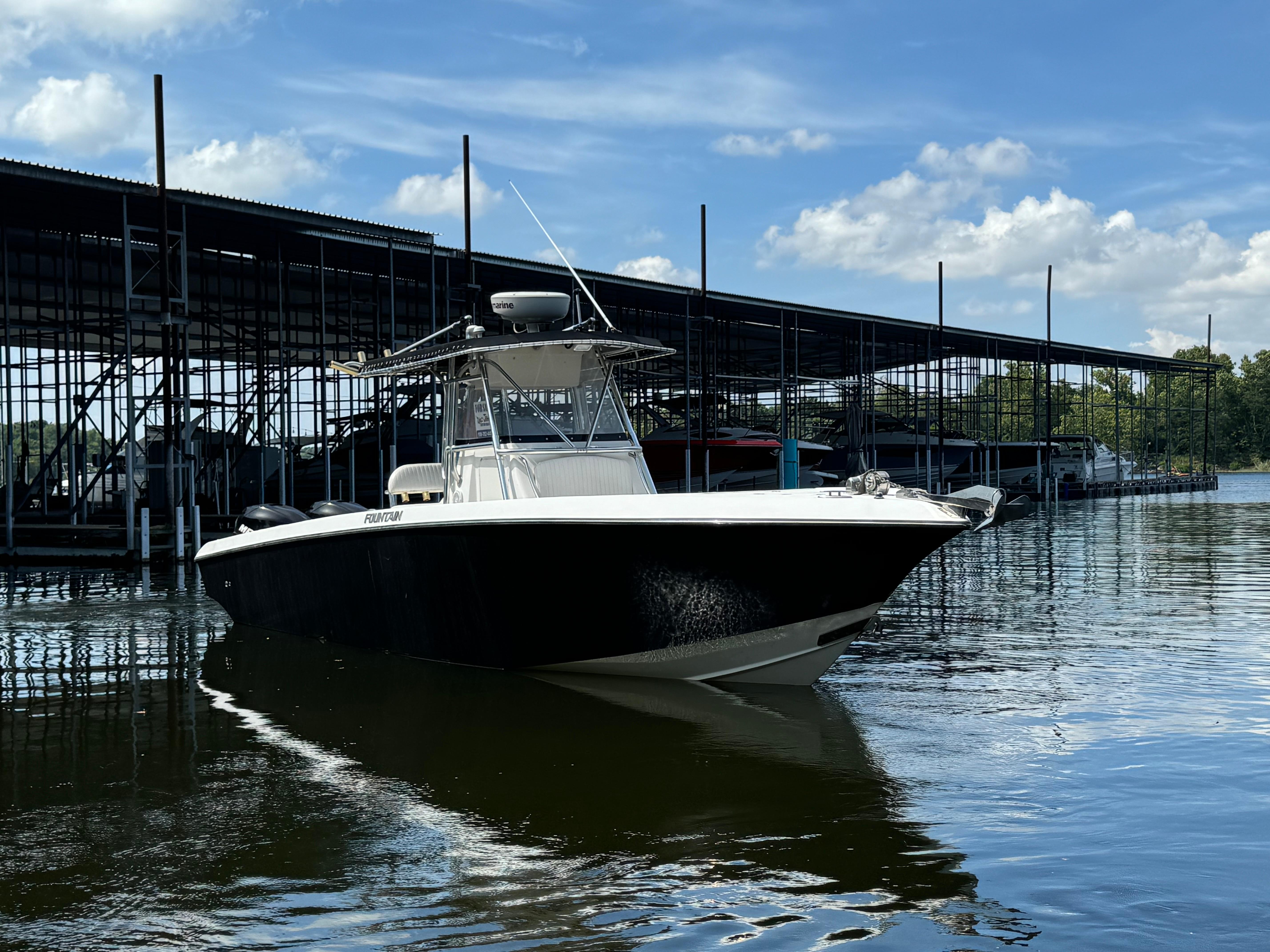 Fountain 32 CC 2007 Fountain 32 CC boat docked at marina under blue sky.