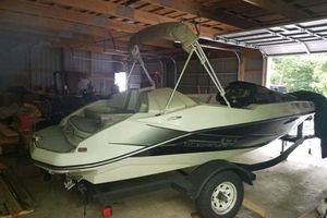 Scarab 165 2015 Scarab 165 boat in a garage, featuring sleek design and trailer.