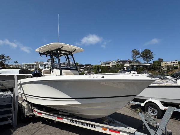 Boston Whaler 230 Outrage 2025 Boston Whaler 230 Outrage boat on trailer under clear blue sky.