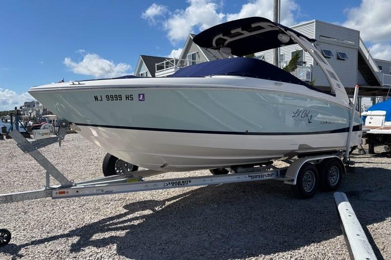 Regal LX4 2023 Regal LX4 boat on trailer, parked outdoors under a clear sky.