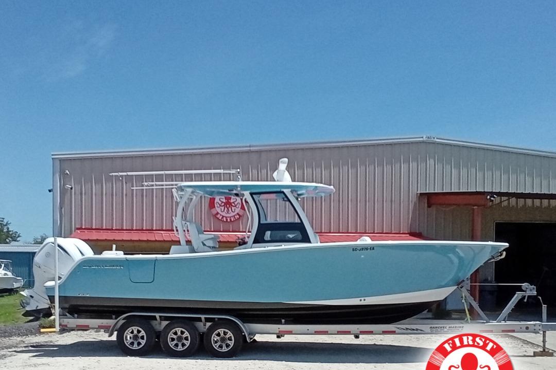 Sportsman Open 302 Center Console 2022 Sportsman Open 302 Center Console boat on trailer, parked outside a warehouse.