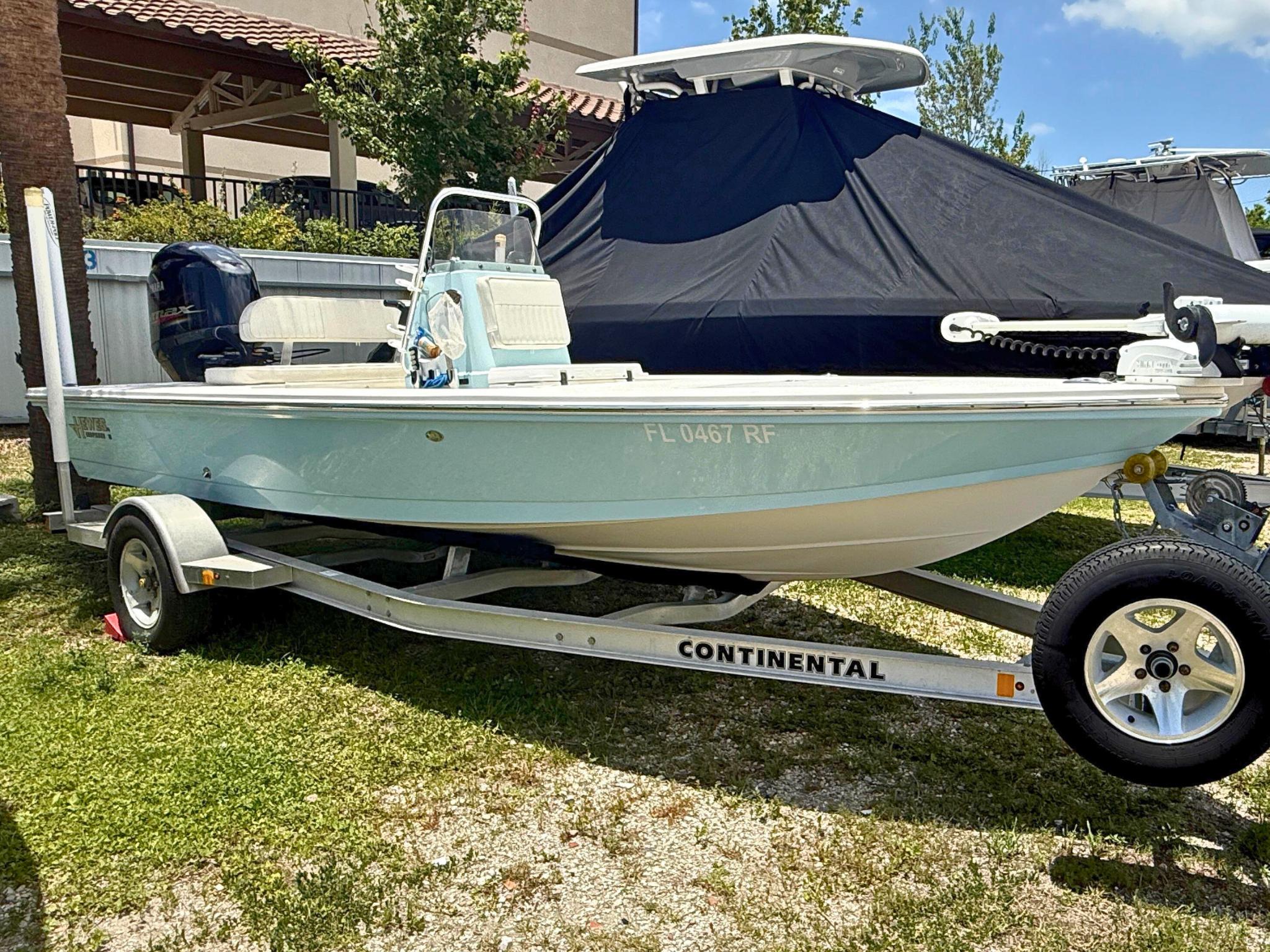 Hewes Redfisher 18 2017 Hewes Redfisher 18 boat on trailer, light blue hull, parked outdoors.