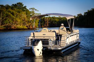 Vision Marine Technologies V24 2025 Vision Marine Technologies V24 pontoon boat cruising on a serene lake.