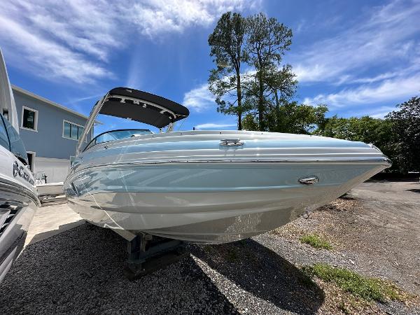 Crownline Eclipse E260 XS 2024 Crownline Eclipse E260 XS boat on display under a clear blue sky.