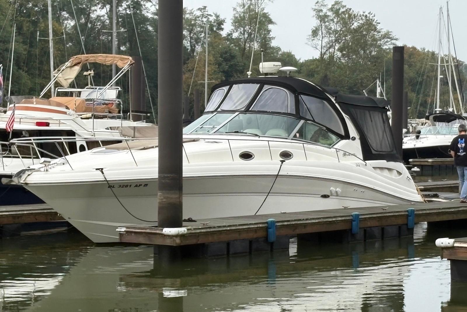 Sea Ray 340 Sundancer 2004 Sea Ray 340 Sundancer docked at a marina with surrounding boats.