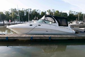 Sea Ray 340 Sundancer 2004 Sea Ray 340 Sundancer docked at a marina, surrounded by other boats.